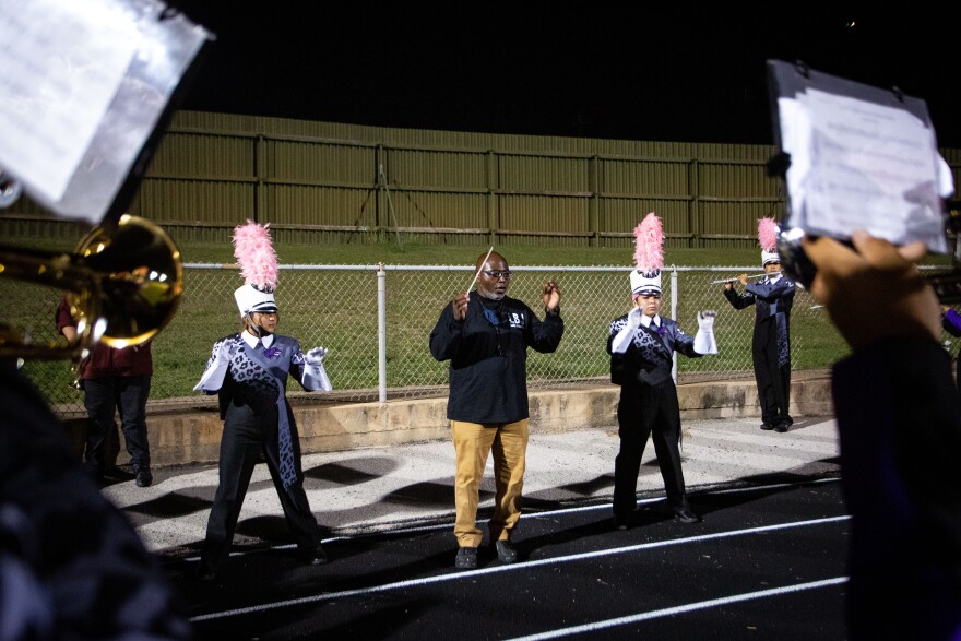 Band Director Darrell Williams rehearses with the LBJ Early College High School band on Oct. 22, 2021 at the high school's homecoming football game at Nelson Field in Austin, TX.