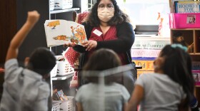 Maria Martinez reads “If You Bring a Mouse to School” to the kindergarten class where she is doing her student teaching at Mark Twain Elementary in Kansas City, Kansas.