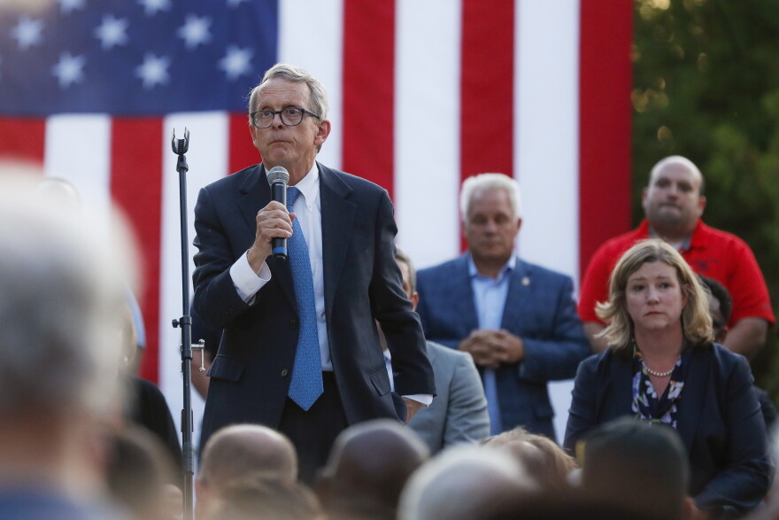Ohio Gov. Mike DeWine, left, speaks alongside Dayton Mayor Nan Whaley, right, during a vigil at the scene of a mass shooting, Sunday, Aug. 4, 2019, in Dayton, Ohio. 
