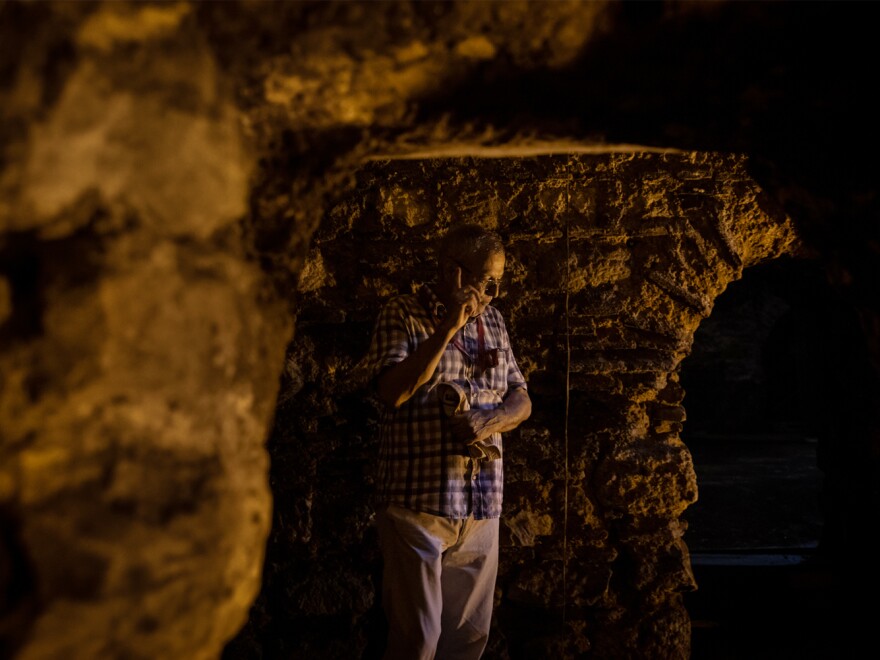 Left: Remnants of pottery and glass are seen among restored Byzantine-era ruins in a basement below a carpet shop. Right: Ozgumus stands in a substructure with mason work he believes dates back to the 4th to 6th centuries. Due to its location and layout, he suggests it may have been a substructure that was part of the palace complex built by Constantine the Great.