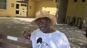 The Reverend Edward Cross seated in the courtyard of Bliss Towers