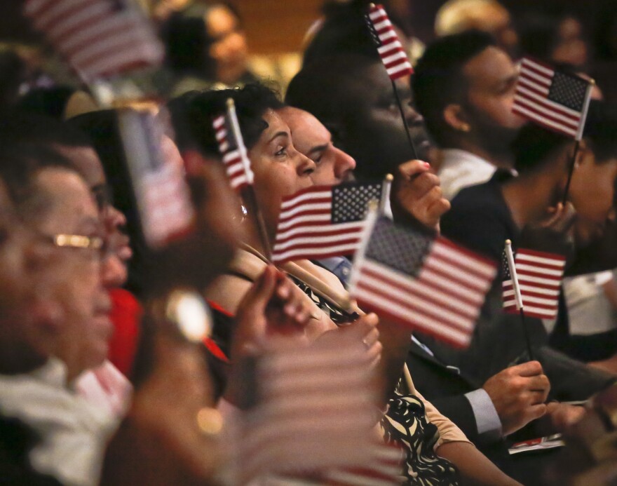 New U.S. citizens wave flags during a special Flag Day naturalization ceremony at the New York Historical Society in New York city.