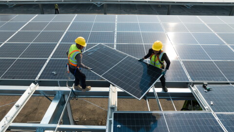 Workers are installing solar panels