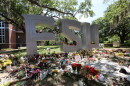 flowers are piled around silver letters that spell FSU