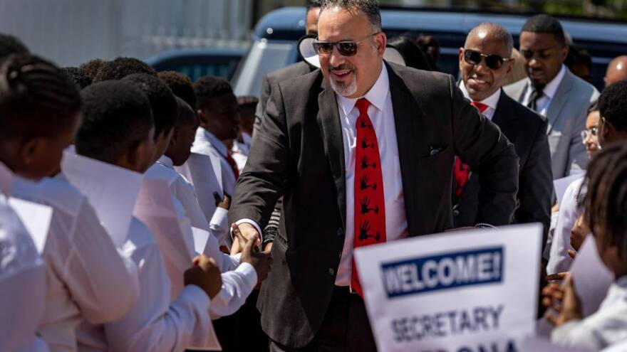 U.S. Secretary of Education Miguel Cardona is welcomed by students Thursday, May 4, 2023, at Dr. Frederica S. Wilson / Skyway Elementary School in Miami Gardens. He and U.S. Rep. Frederica S. Wilson highlighted the 5,000 Role Models mentorship program for young men in Miami-Dade public schools. Cardona slammed the education bills coming out of the Florida Legislature, saying they are the ‘opposite’ of what’s needed to solve the nation’s teacher shortage.