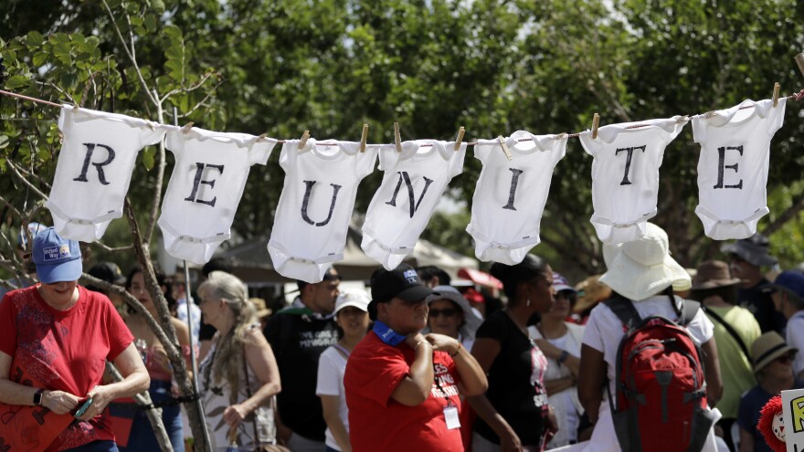 Protesters use baby cloths to display a message during an immigration really across from the federal courthouse in Brownsville, Texas on Thursday.