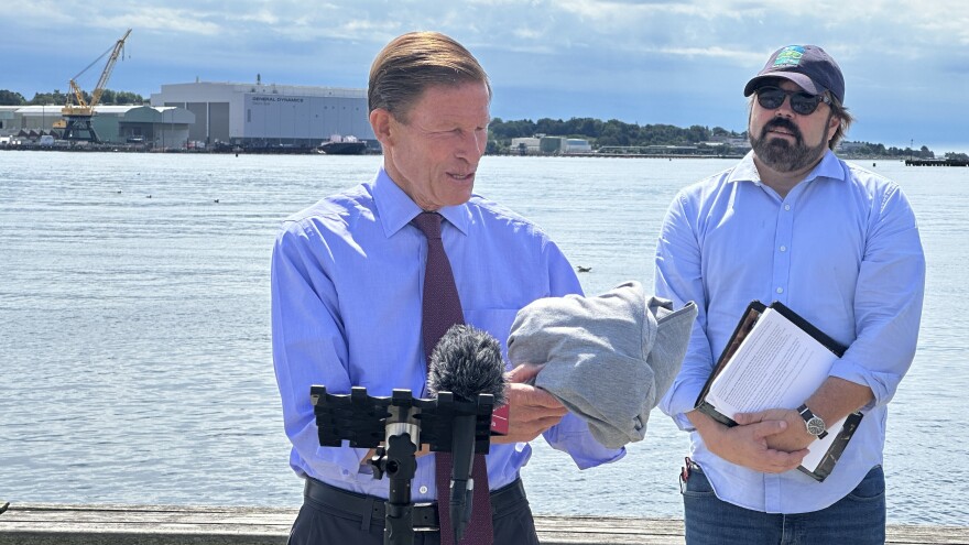 U.S. Sen. Richard Blumenthal (D-CT) holds up a piece of clothing made from plastics that can break down in to microplastics over time