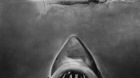 Susan Backlinie swims as the great white shark rises toward her in publicity art for the 1975 film <em>Jaws</em>.
