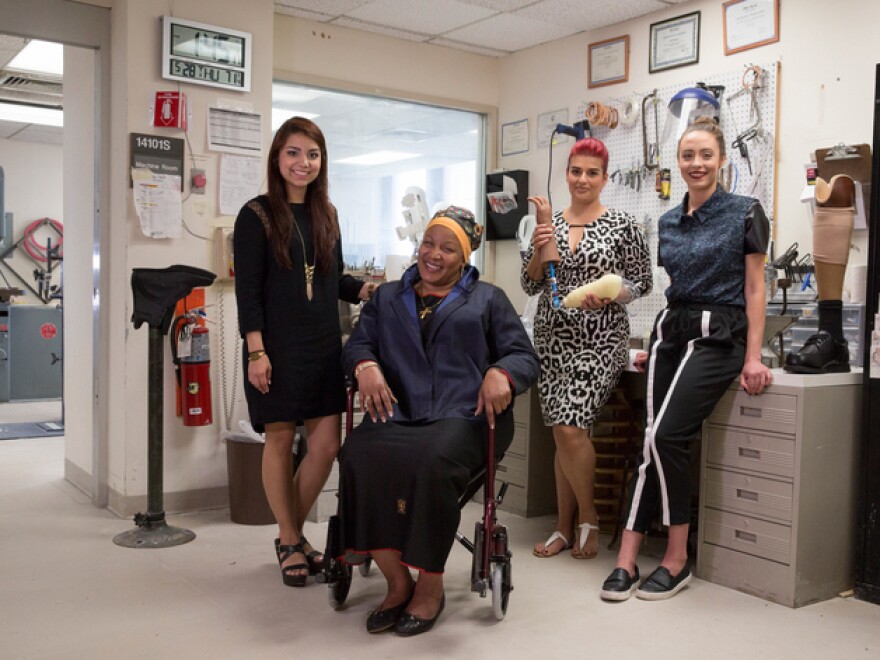 Fashion Institute of Technology students Erika Morales (left) and Nas Rivera (third from left) worked with Air Force veteran Anna Smith (seated) and fit model Samantha Poulis to design and produce clothes for people with disabilities, including amputees and people who use a wheelchair.