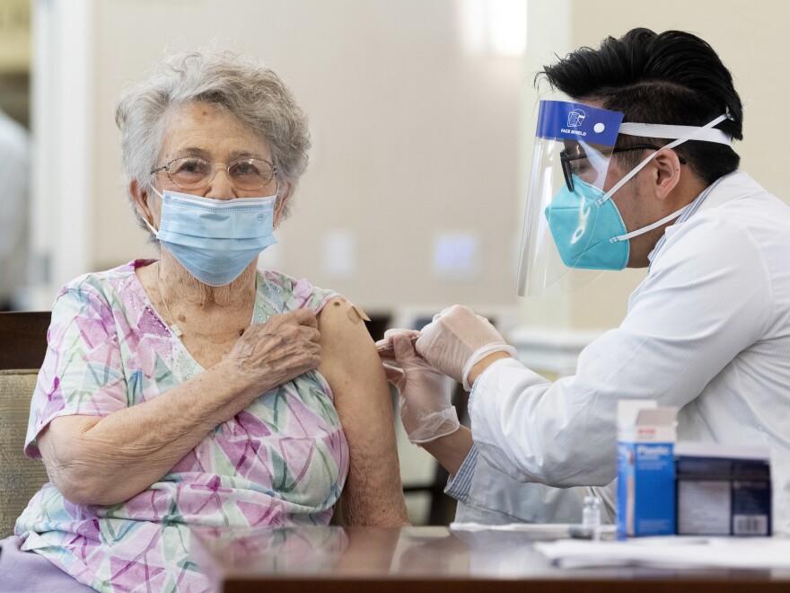 ANAHEIM, CA - JANUARY 08: A CVS pharmacist gives the Pfizer/BioNTech COVID-19 vaccine to a resident at the Emerald Court senior living community in Anaheim, CA on Friday, January 8, 2021. The vaccine was optional for staff and residents. (Photo by Paul Bersebach/MediaNews Group/Orange County Register via Getty Images)