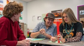 Bailey Heugly, right, and Jaythen Flowers, middle, record data while Landon Mingo, left, looks on during a data science class at Lehi High School in Lehi, Utah, Nov. 24, 2025.