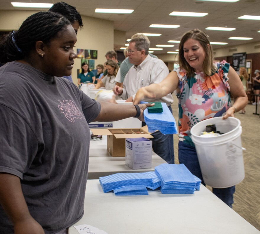 Volunteers pack relief buckets with cleaning supplies to be sent to Kerr County. The buckets will be distributed to Kerr County residents to help with cleanup efforts.