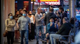 People enjoy eating outdoors on Wednesday in Melbourne, Australia. Lockdown restrictions in the city were lifted after 111 days, allowing people to leave their home for any reason.