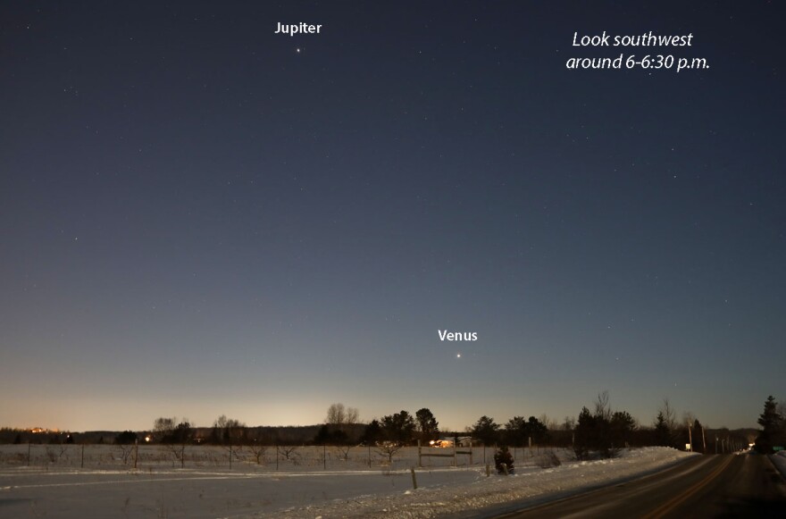 Jupiter and Venus in the western sky over a snow covered landscape