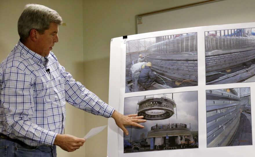 Part of Bertha's seal, which project manager Chris Dixon points to during a news conference on Feb. 11, has apparently been compromised.