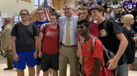 Gov. Eric Holcomb poses with teens at Fishers High School.