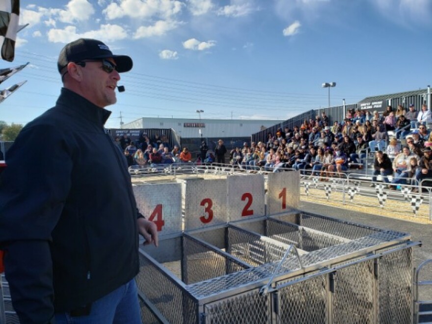 Zach Johnson of Swifty Swine Racing calls the action during the pig races