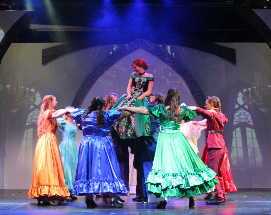 The ensemble lifts Anna at her sister's coronation ball.