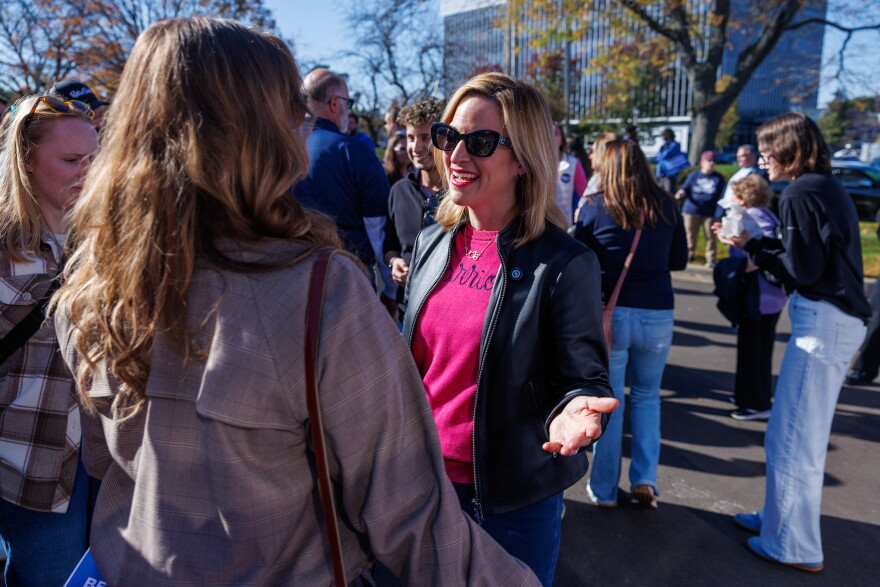 Democratic nominee for governor Jocelyn Benson speaks with a supporter in East Lansing, Mich., during the first stop on her statewide "Driving Down Costs" bus tour on Oct. 22, 2026.