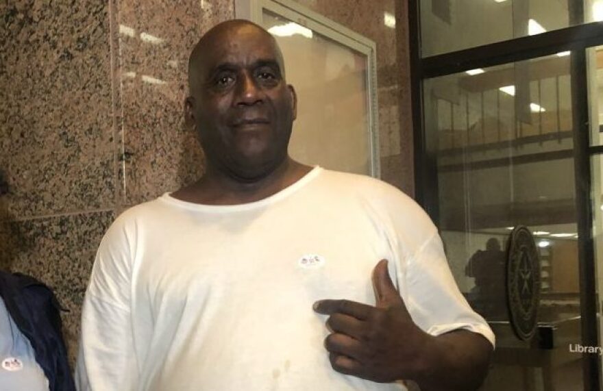 Hervis Rogers points to his "I voted" sticker on Super Tuesday in 2020. This week he was arrested for allegedly voting while on parole, which is illegal in Texas.