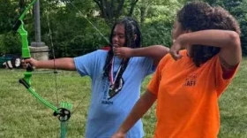 Women learning archery