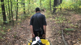 An emergency responder carries a stretcher into the Charles Deam Wilderness Area, Sept. 30