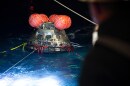 In this photo provided by NASA, NASA's Orion spacecraft is seen as the agency's Landing and Recovery team, along with U.S. Navy personnel work to recover the spacecraft into the well deck of USS John P. Murtha in the Pacific Ocean off the coast of California, Saturday, April 11, 2026. (Joel Kowsky/NASA via AP)