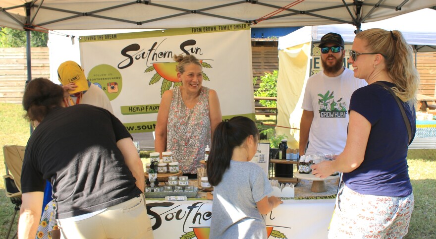 Barbara Stalbaum and Tyler Griffin, helping customers at Gainesville Grove Street Farmers Market, October 10, 2022. (Ismara Corea/WUFT News)