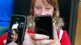 Emilie Weideman and her father, Marc Weideman try their new iPhones Thursday in Palo Alto, Calif. Many of the new phones' owners are complaining of a glitch that drops calls.