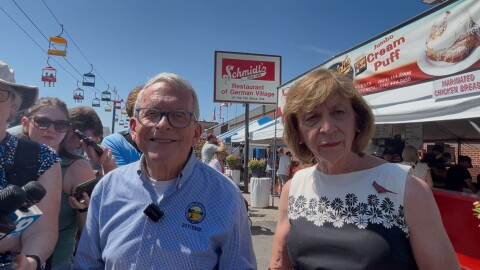 Ohio Gov. Mike DeWine and First Lady Fran DeWine speak to reporters on the midway at the 2025 Ohio State Fair in Columbus.