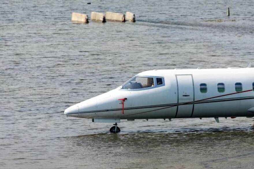 A private jet charter sits in floodwaters at Fort Lauderdale-Hollywood International Airport on Thursday, April 13, 2023.