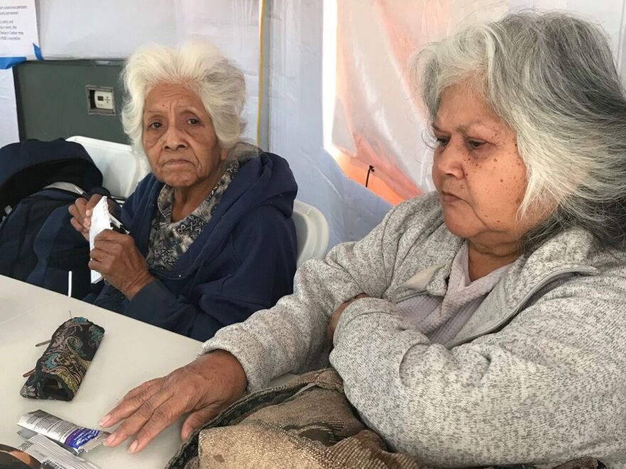During recent blackouts in California, people like Fern Brown (left) and her sister, Lavina Suehead, came to a pop-up community center at the Auburn, Calf., fairgrounds to use electricity. Brown, 81, needed a treatment for her chronic lung condition.