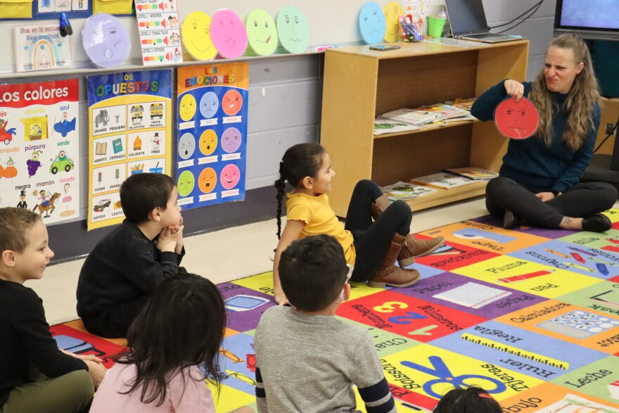 Kindergarten teacher Alanna Langley and her students practice identifying emotions in Spanish.