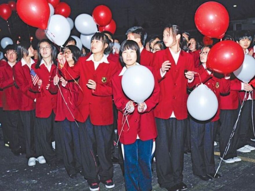 Students from China celebrate the dedication of the Taylor International School and dorm, where they live while attending Lake Shore High School in St. Clair, Mich.