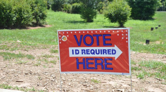 An early voting sign posted in an opened field.