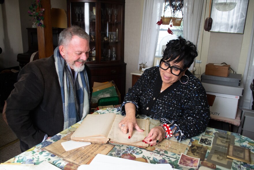 Eastern Mennonite University Professor Mark Sawin, left, and Harrisonburg Mayor Deanna Reed review a local church ledger from the 1880's and 90's.
