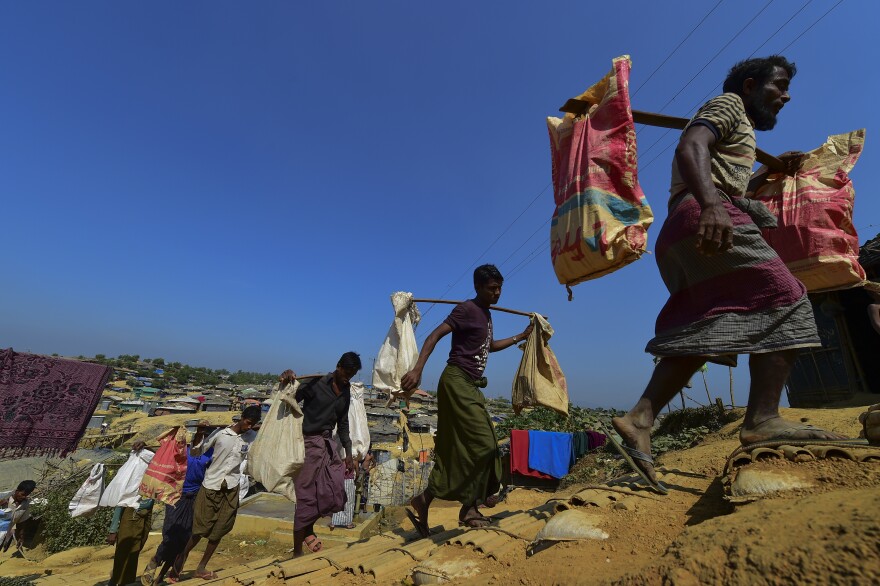 Rohingya Muslim refugees carry brick to make road at Kutupalong refugee camp in Bangladesh's Ukhia district on Jan. 23.