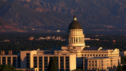 The Utah Capitol building is backed by mountains. 