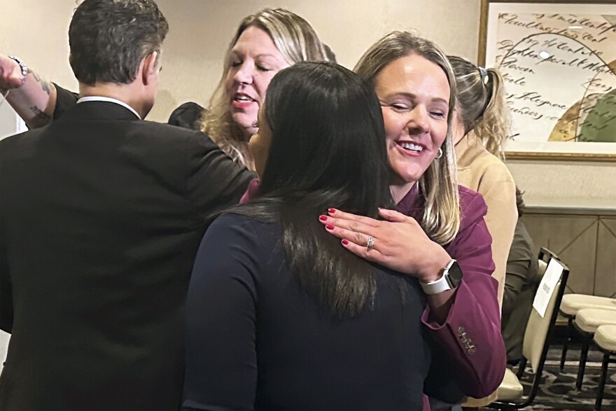 Attorney Kelly Fitzpatrick, right, hugs plaintiff Soryorelis Henry, foreground right, after a news conference in New Haven, CT, Monday, Sept. 9, 2024, where dozens of women who say they suffered excruciating pain at a Yale University fertility clinic because a nurse stole fentanyl for her own use and replaced it with saline, have settled their lawsuits against the Ivy League school.