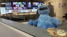 FILE - A stuffed Cookie Monster is seated in a control room at the Arizona PBS offices at the Walter Cronkite School of Journalism and Mass Communication in Phoenix, Friday, May 2, 2025. (AP Photo/Katie Oyan, File)