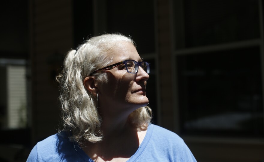 Melissa Preen stands beside boxes filled with her belongings as she prepares to move back to Cleveland, Ohio. She says she can no longer afford to live in Country Villa Estates in Riverview, Florida, due to rising lot rent and other fees.