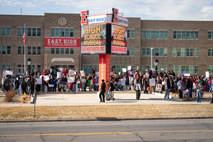 Students protesting immigration enforcement stand outside of East High School, holding signs that say things like “no one is illegal on stolen land,” Feb. 6, 2026. The students walked out of class to protest.