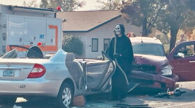 The Grim Reaper, played by a Springfield Police Officer, lingers on the scene of a deadly mock car crash.