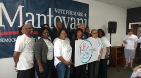 Members of the Fannie Lou Hamer Democratic Coalition stand with businessman Mark Mantovani, in back, at an endorsement event on May 5, 2018. 