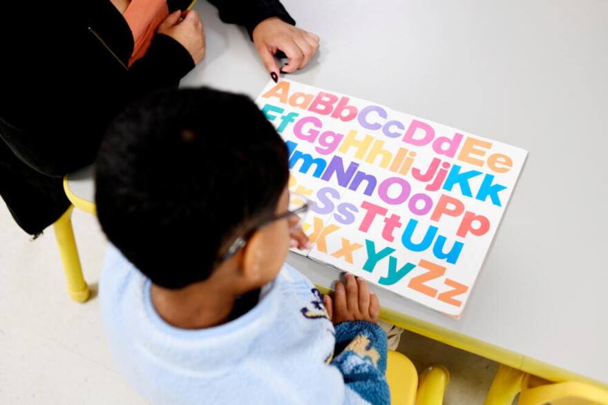 Joanna Isitt, 28, reads with her son, Xavier Rogers, 4, before teaching her Head Start class at Hometown Child Care on Wednesday, Sept. 23, 2026, in Aurora, Ill. (Octavio Jones/AP)