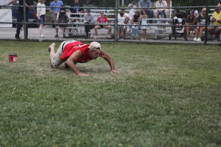 Joel Pariseau jumping his frog during the Wisconsin State Frog Jump in Dousman. (credit: Dan Wanschura / Points North)