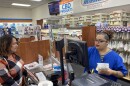Customer Lisa Durs is helped by pharmacy clerk Kira Tomoney at Minnich's Pharmacy in York County.