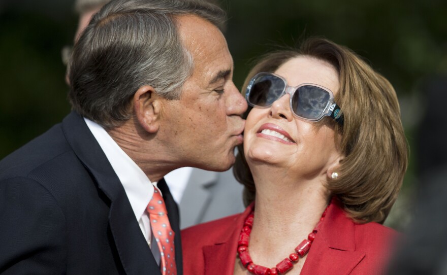 FILE - House Speaker John Boehner of Ohio, left, kisses House Minority Leader Nancy Pelosi of Calif., right, in the Rose Garden of the White House before President Barack Obama's remarks to members of Congress, April 21, 2015 in Washington. (AP Photo/Pablo Martinez Monsivais, File)