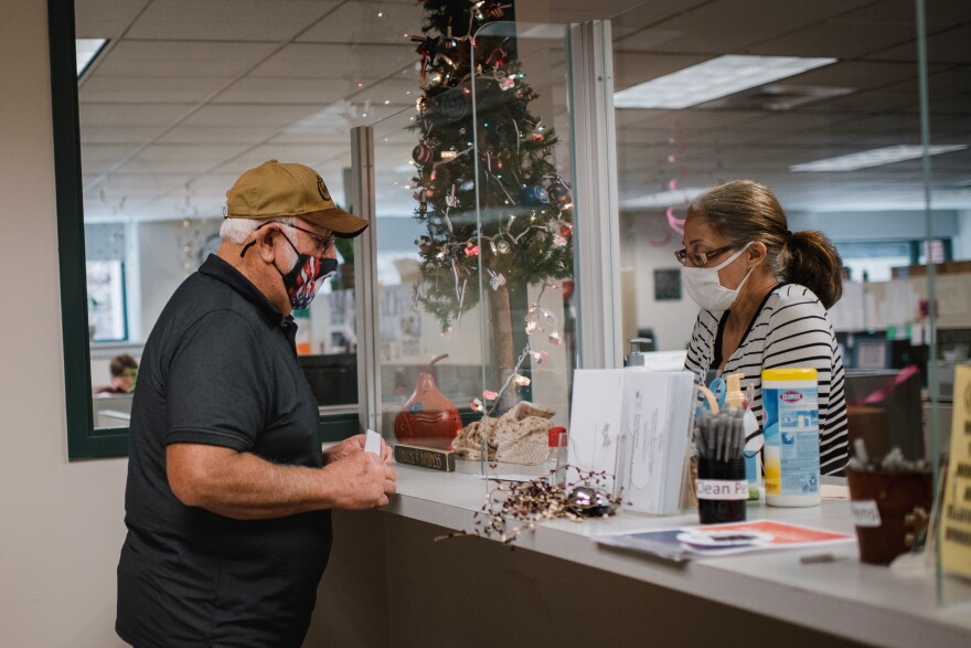 Morris Romig drops off his voter mail-in ballot application at the Voter Registration office. Romig said he's worried about fraud and doesn't know who to believe. He said he's going to vote one way or another in this election.