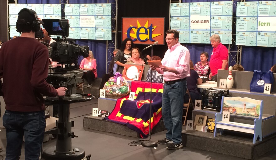 An auctioneer sells a board at the 2019 Action Auction at WCET-TV.